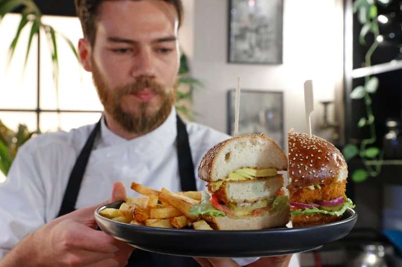 Israeli chef Shachar Yogev serves a burger made with 'cultured chicken' meat