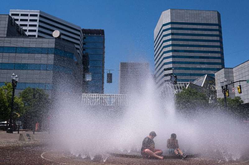 Kids cooling off at a fountain in Portland, Oregon on June 27 2021 in the midst of a record busting heat wave across the western