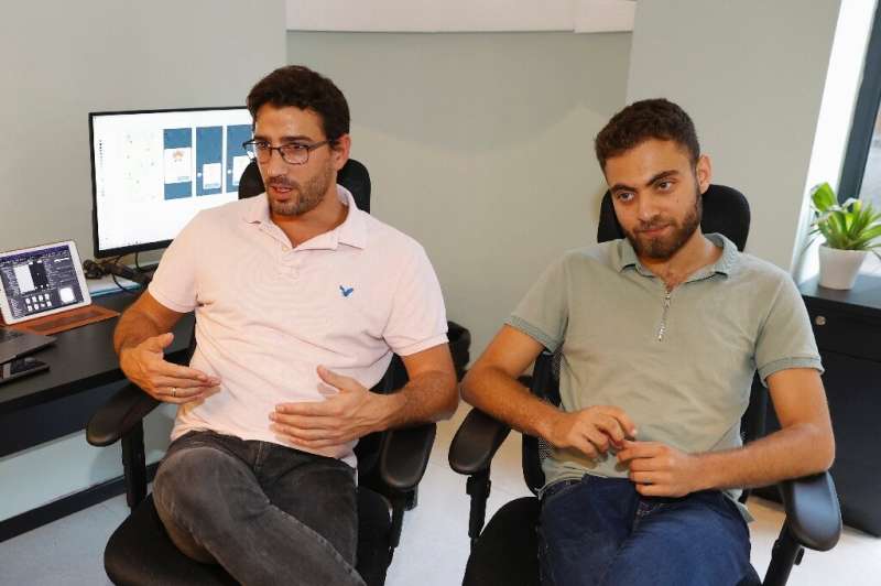 (L to R) Clean Coin co-founders Adam Ran and Gal Lahat are pictured at their office in Israel's northern city of Haifa. The comp