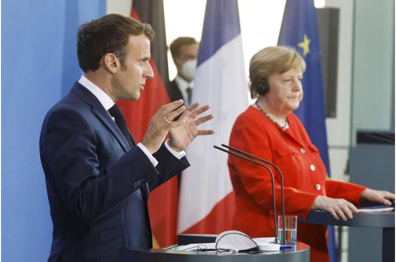 Leaders of Germany, France urge vigilance over virus variant
