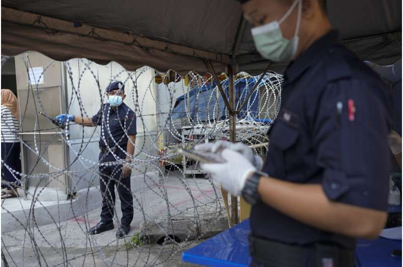 Malaysia imposes near-total lockdown after virus cases soar