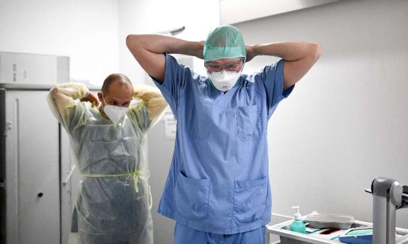 Medical workers in Germany get ready as the WHO warns that the Omicron could overwhelm health systems across the world