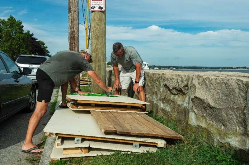 Members of a private beach association for Guthrie Beach tie down and disassemble beach huts prior to the arrival of Hurricane H