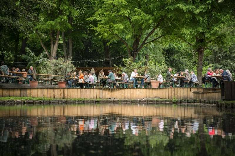People enjoy sunny weather at a beer garden in Berlin on May 21, 2021