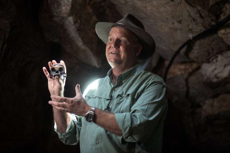 Professor Lee Berger shows off a full-scale reproduction of the skull of a hominid named Leti