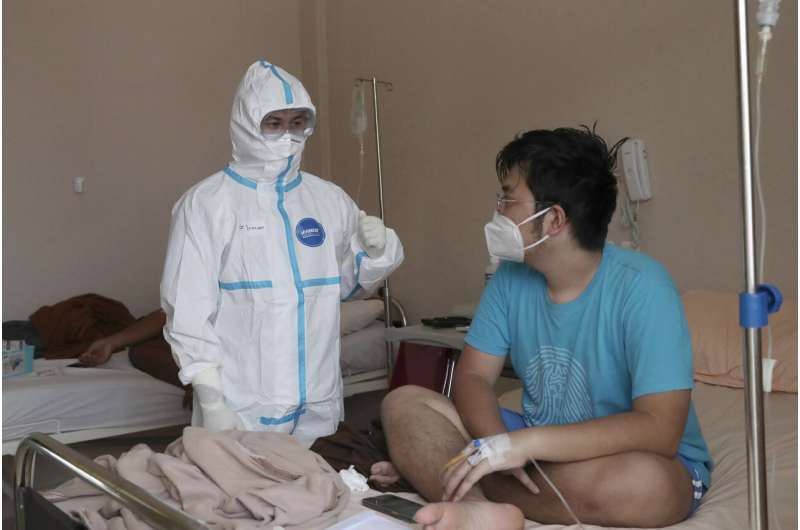 Rapid virus spread through Indonesia taxes health workers