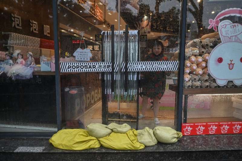 Residents of Ningbo have been preparing for the coming typhoon, which is already bringing strong gusts and rain