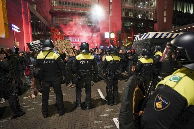 Riot police faced protesters in The Hague as the Dutch premier announced a fresh partial lockdown