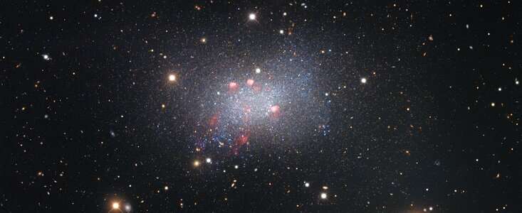 Star-studded image of the Sextans B dwarf galaxy showcases astronomical curiosities near and far