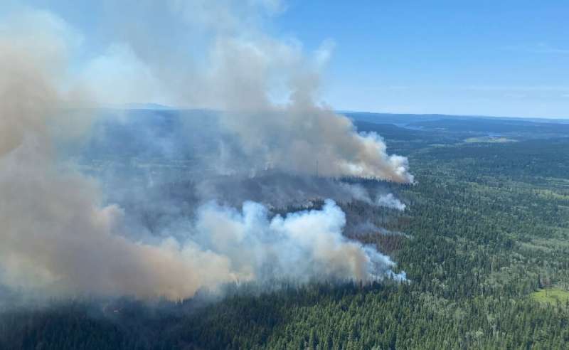 This handout photo courtesy of BC Wildfire Service shows a wildfire southwest of Deka Lake, British Columbia, on July 2, 2021