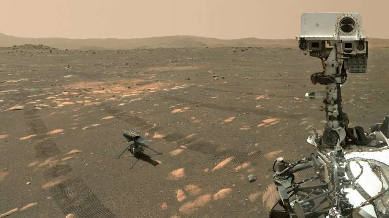 This NASA photo shows the Perseverance Mars rover in a selfie with the Ingenuity helicopter, seen here about 13 feet (3.9 meters