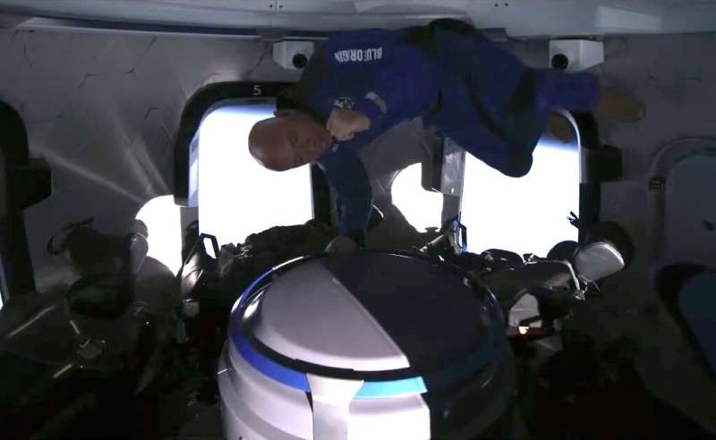 This still image taken from video by Blue Origin shows the space company's founder Jeff Bezos celebrating catching popcorn in hi