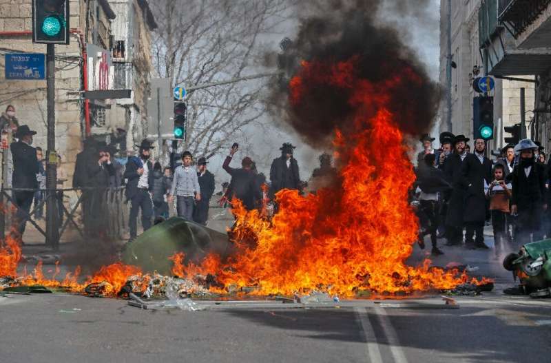 Ultra-Orthodox Jewish protesters clash with Israeli security forces during the enforcement of the coronavirus emergency regulati