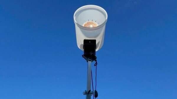 Using optical beaming to power a portable 5G base station