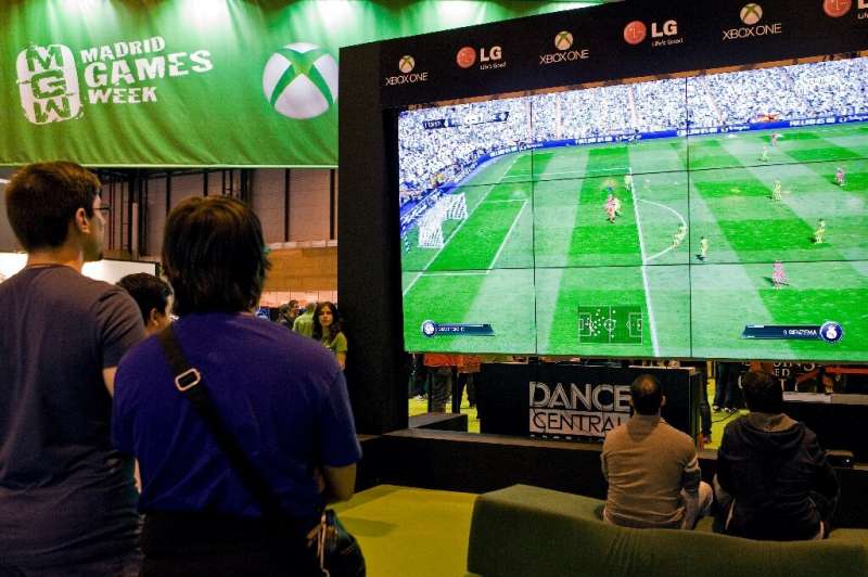Visitors play a FIFA football video game in Madrid, Spain in October 2014