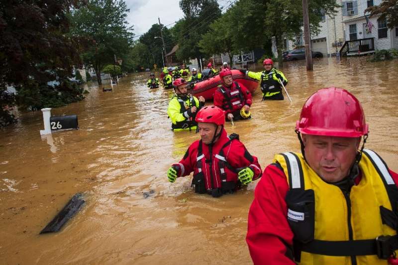 Volunteer firefighters perform a secondary search during an evacuation effort in Helmetta, New Jersey on August 22, 2021