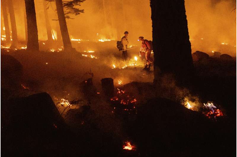 Western wildfires calm down in cool weather, but losses grow