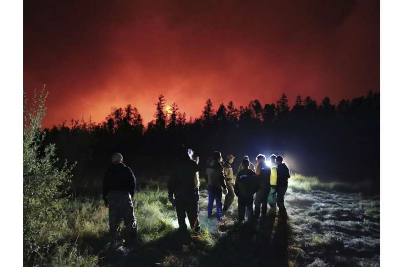 Wildfires endanger villages, fuel site, in Russia's Siberia