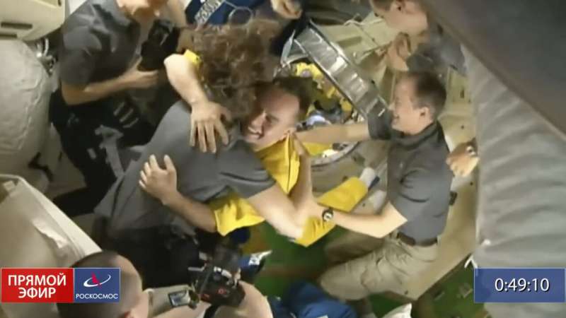 3 cosmonauts arrive at space station in yellow and blue
