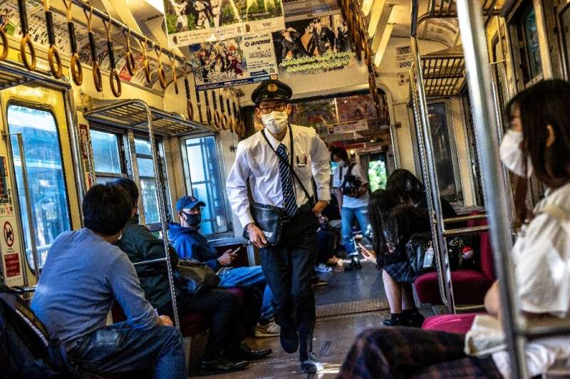 A conductor hustles through the train after checking tickets on the Choshi Electric Railway Line in northeast Chiba prefecture