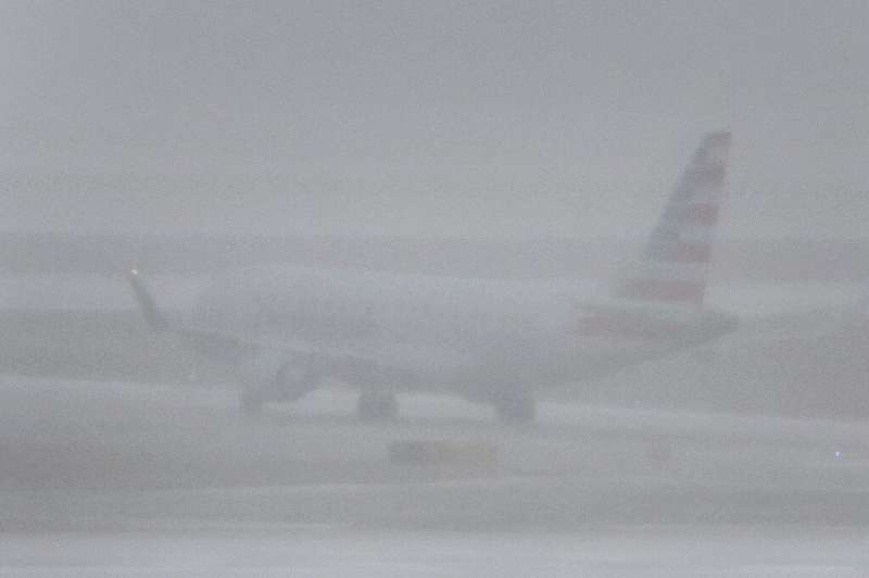 A jet takes off at O'Hare International Airport in Chicago, Illinois during a massive winter storm bringing snow, high winds, an