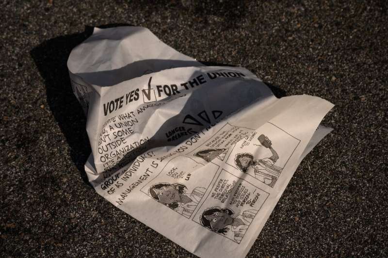 A leaflet is discarded as workers make their way to cast their vote over whether or not to unionize, outside an Amazon warehouse