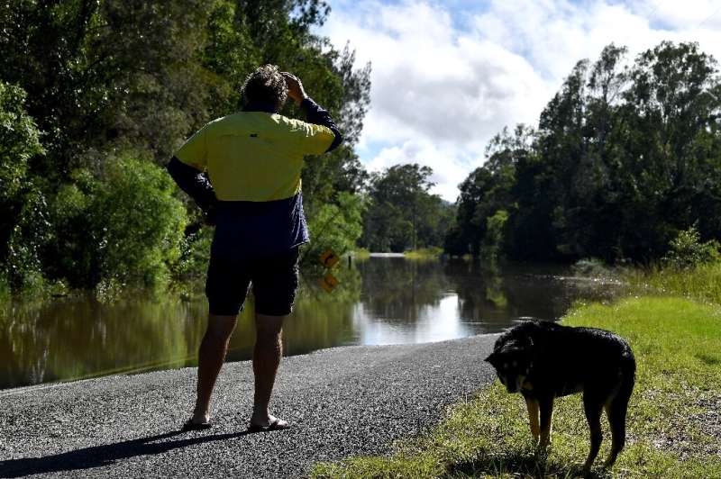 A local farmer watched the rising flood waters in the outskirts of Grafton, New South Wales, which this week saw buildings subme
