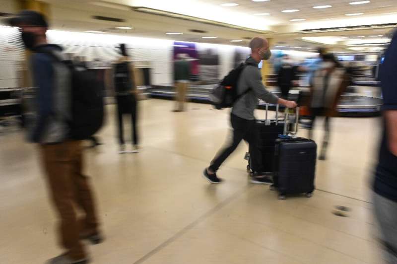 A man leaves the baggage carrousel area at Ronald Reagan International Airport in Washington in December 2021