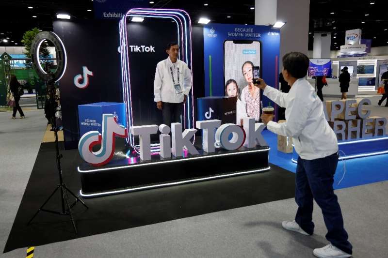 A man poses at the TikTok booth at the international media centre during the Asia-Pacific Economic Cooperation (APEC) summit in 