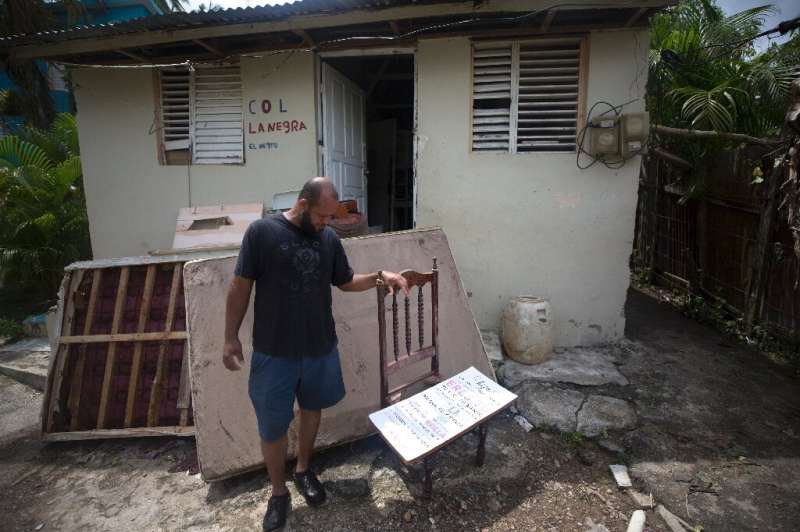 A man stands outside his home after Hurricane Fiona in El Sebo, Dominican Republic