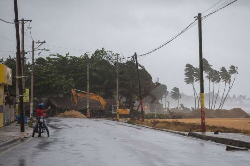 A man takes pictures in Nagua in the Dominican Republic as Hurricane Fiona made landfall along the eastern coast