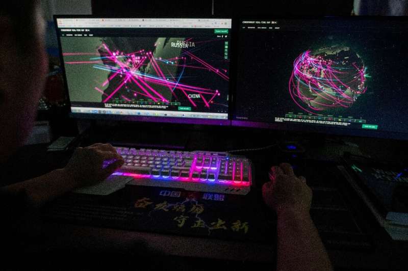 A member of the Red Hacker Alliance in Dongguan, China in August 2020 monitors cyberattacks around the world. Hacks have increas