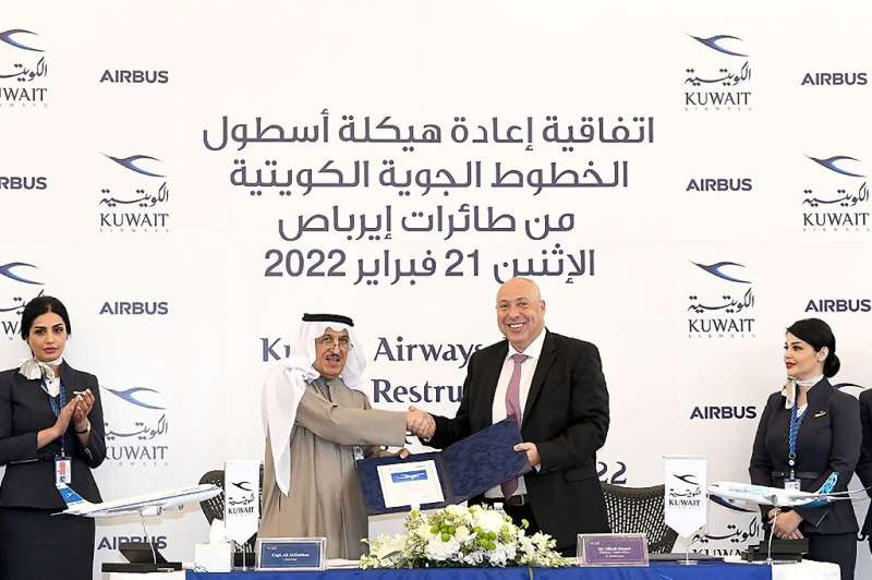 A photo provided by the Kuwaiti news agency KUNA shows the Chairman of Kuwait Airways Ali Al-Dukhan (C-L) shaking hands with Mik