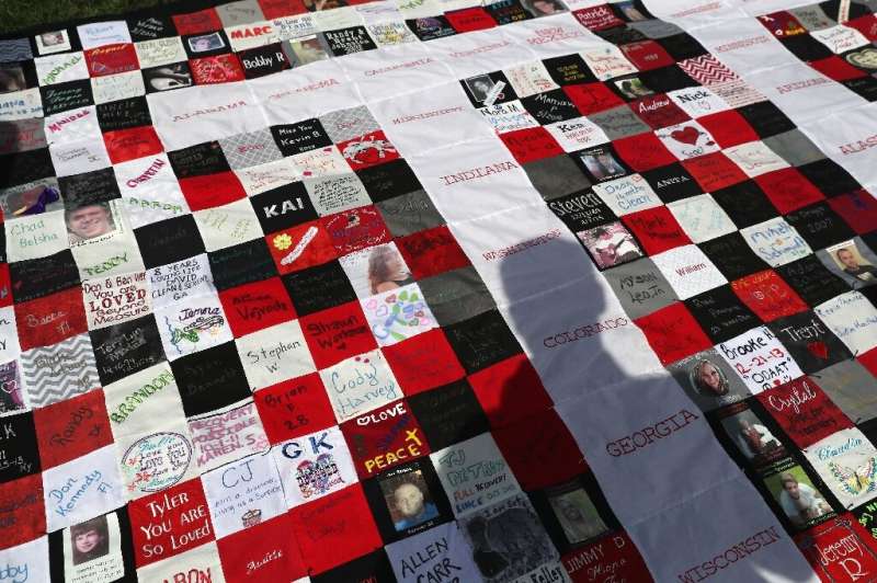 A quilt made in honor of people who died of opioid and heroin overdoses take part in the 'Fed Up!' rally to end the national epi
