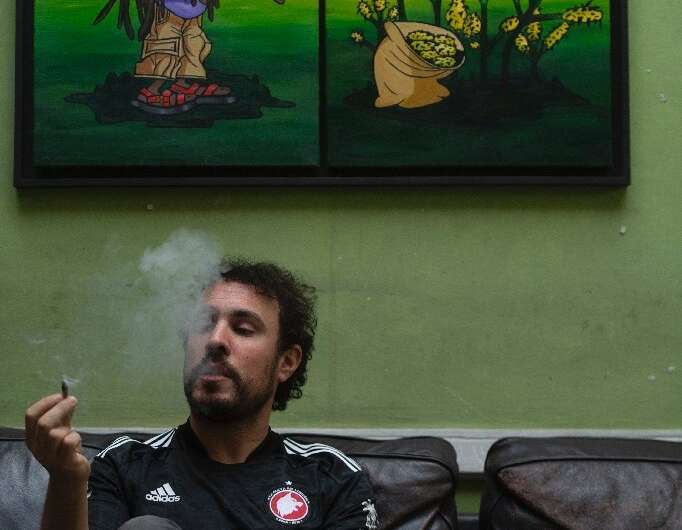 A registered user smokes cannabis at a legal marijuana club in Montevideo
