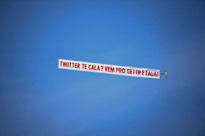 A small plane carries a banner that reads &quot;Twitter shuts you up? Come to GETTR and talk&quot;, in promotion of the US socia