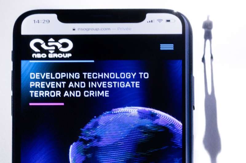 A smartphone with the website of Israel's NSO Group which features the Pegasus spyware