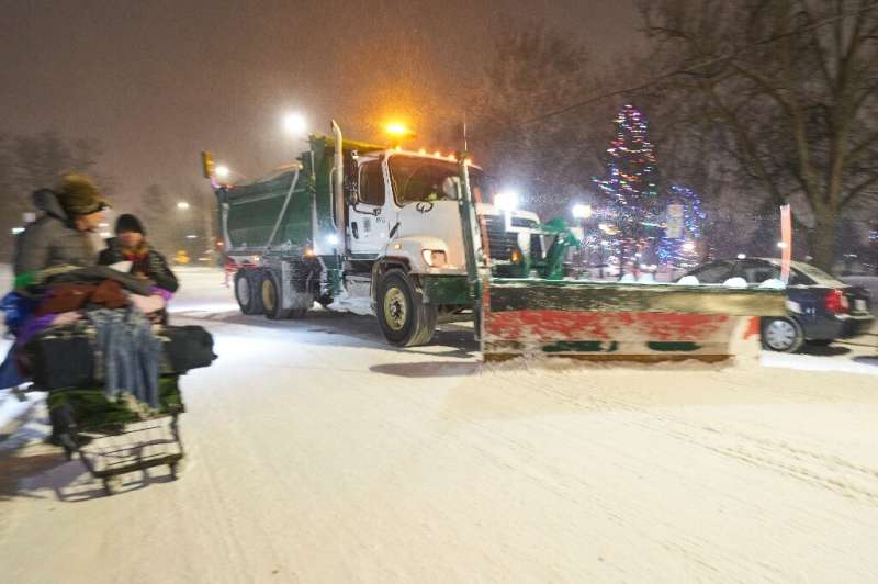 A snowplow clears a road on December 23, 2022, in London, Ontario in Canada during the severe winter storm that battered North A