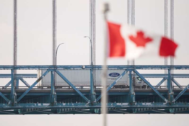 A tractor trailer drives across the Ambassador Bridge border crossing from Windsor, Ontario in Canada to Detroit, Michigan in th