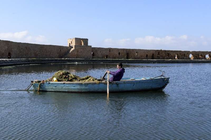A Tunisian fisherman enters port in Ghar el-Melh; fishing makes up 13 percent of Tunisia's GDP, and nearly 40 percent of it is d