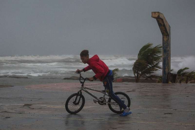 A young person rides his bicycle in Nagua, Dominican Republic