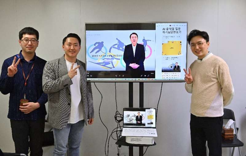 AI Yoon team director Baik Kyeong-hoon (R) and his colleagues pose with the avatar