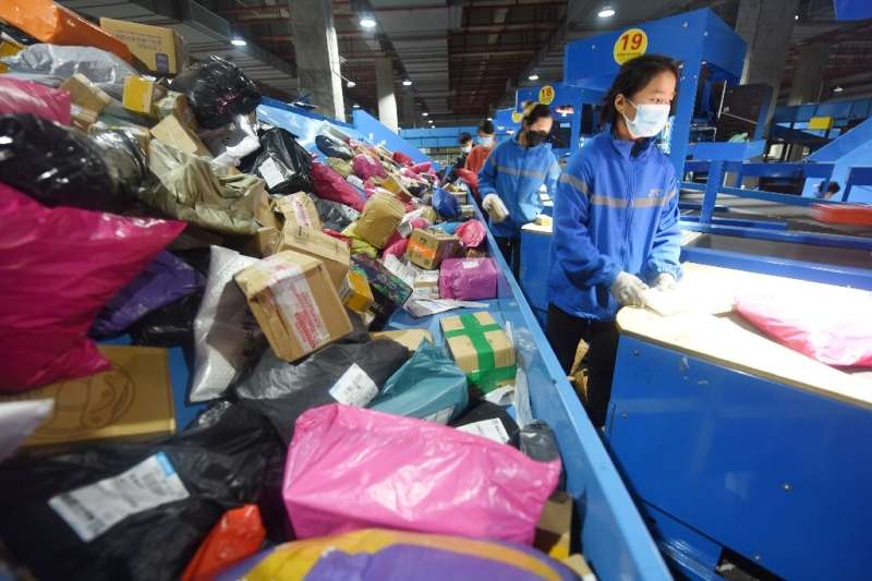 An employee arranges packages for delivery during the Singles' Day shopping festival at a logistics center in Donghai, China