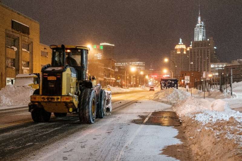 An excavator makes its way through Buffalo, New York on December 27, 2022