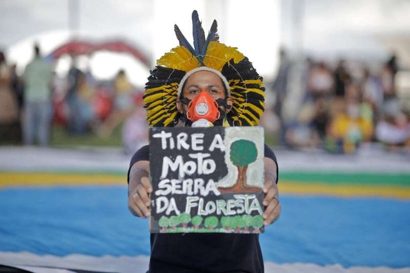 An indigenous man in Brazil protests against deforestation and the environmental policies of  President Jair Bolsonaro in Brasil