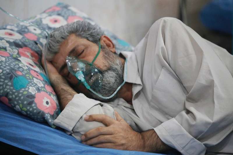 An Iraqi man is treated for breathing difficulties at a Baghdad hospital's emergency ward as choking clouds of dust blanket the 