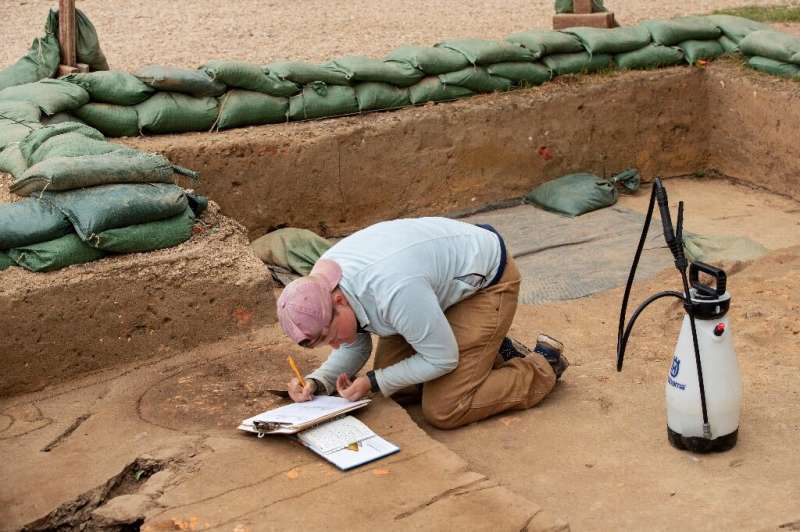 Archeologist Caitlin Delmas works on a dig site at Jamestown, Virginia in May 2022, surrounded by sandbags to protect against ri
