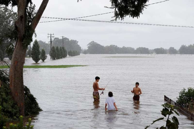 Australia's emergency services ordered 200,000 people on Thursday to flee from the path of a wild storm that has killed 13 peopl
