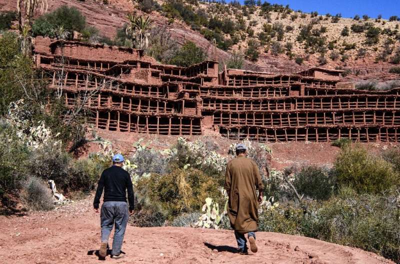 Beekepers walk towards the Inzerki apiary; experts say it is the oldest traditional, collective beehive in the world, but today 