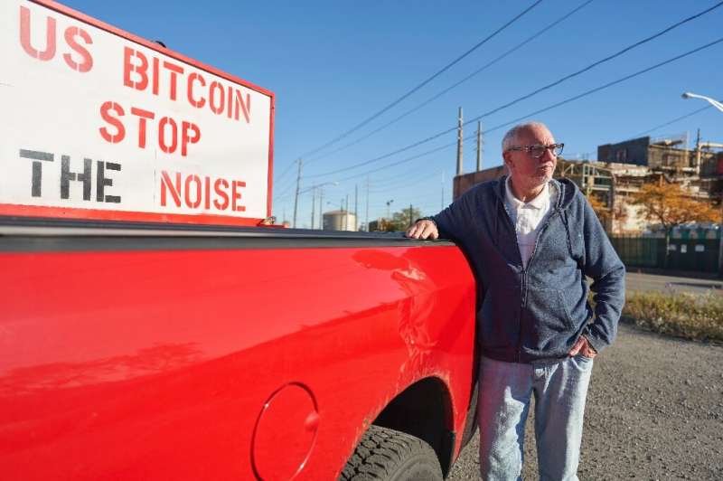 Bryan Maacks holding a sign protesting outside of one of the US Bitcoin companies located in the City of Niagara Falls, NY.